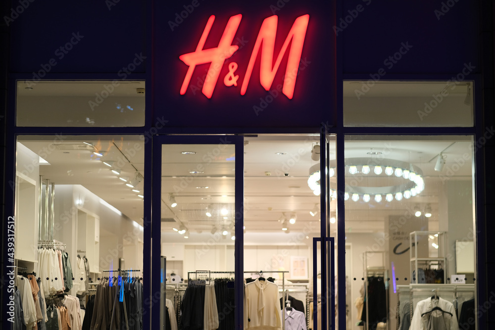 Shanghai.China-June 2021: Facade of H&M clothing store at night. Red logo  on entrance. A Swedish fashion brand Stock Photo | Adobe Stock