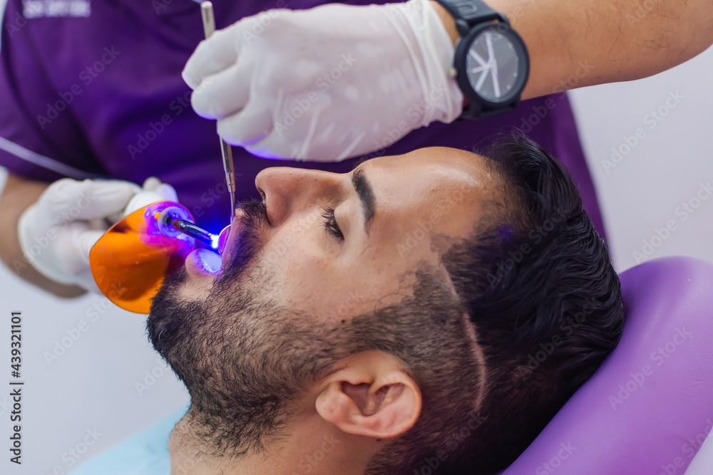 Dentist making dental examination to a patient in the dental office Dentist making dental examination to a patient in the dental office