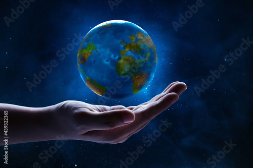 Human hand holding planet earth