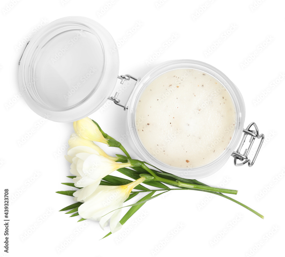 Jar of exfoliating salt scrub and freesia flowers on white background, top view Jar of exfoliating salt scrub and freesia flowers on white background, top view