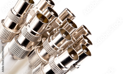 Macro shot of coaxial TV cable connectors for video signal isolated on white background.
