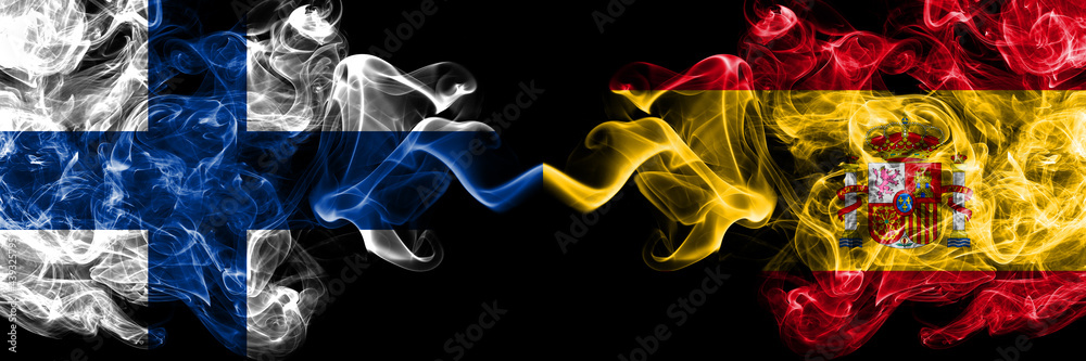 Finland, Finnish vs Spain, Spanish smoky flags side by side. Finland, Finnish vs Spain, Spanish smoky flags side by side.
