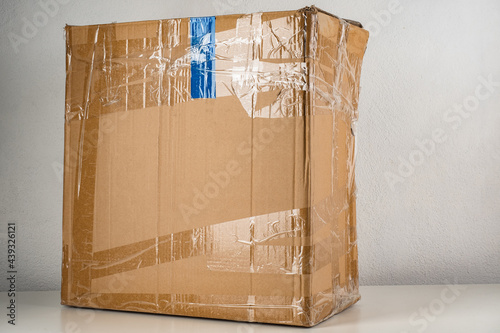 Old cardboard box partially...
