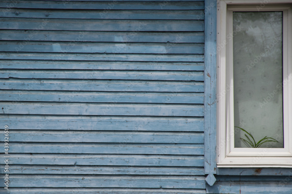 Rustic background. A blue wooden wall with a white window on the right. Rustic background. A blue wooden wall with a white window on the right.