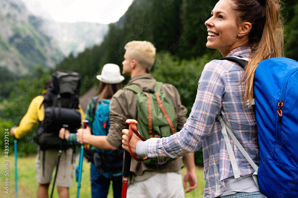 Group of friends with backpacks doing trekking excursion on mountain Group of friends with backpacks doing trekking excursion on mountain