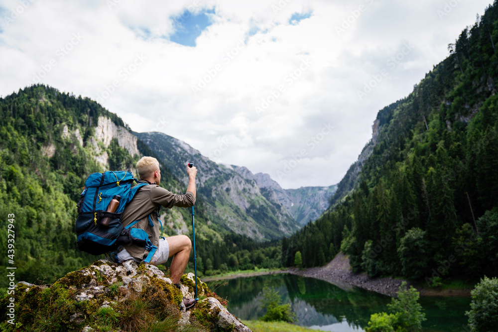 Active healthy man hiking in beautiful nature. Outdoor activity, sport conecpt