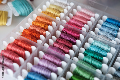 Close up of colorful embroidery floss bobbins in the box. Embroidery threads for handmade  crafts  hobbies.