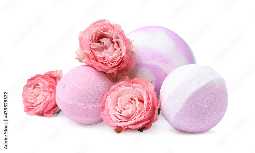 Fragrant bath bombs and rose flowers on white background Fragrant bath bombs and rose flowers on white background