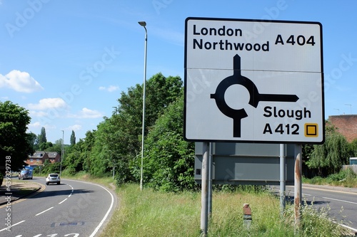 Road sign with directions for London Northwood A404 and Slough A412 photo