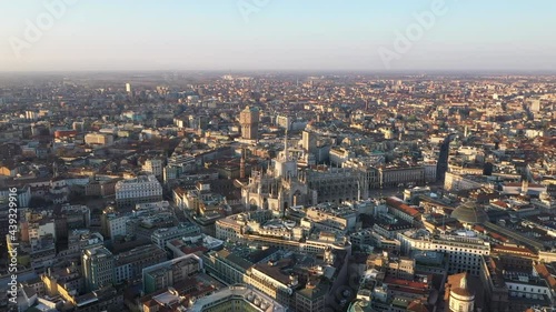 Aerial drone footage view of sunrise of famous statue on cathedral Duomo in Milan Italy  // no video editing