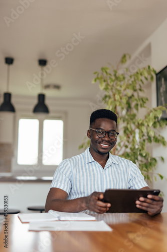 Adult black man, relaxing and smiling for the camera.