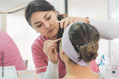 Tableau sur toile Young woman getting ready to put on makeup for a special event.