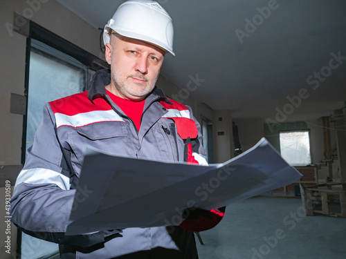 Builder worker looks at cam...
