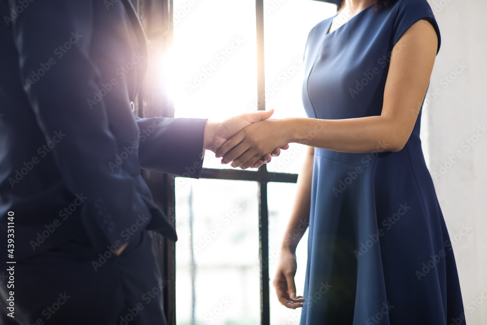 businessman and business woman shaking hands together on a business cooperation agreement. Successful businessmen handshaking after good deal