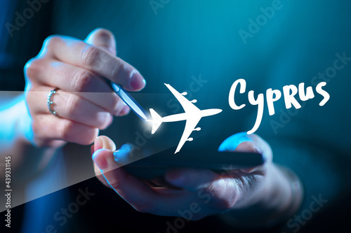 Buying air tickets to Cyprus via smartphone. Phone is in hands of a man. Girl is planning a trip to Cyprus on phone. Cyprus flight logo near smartphone. Cypriot apps for smartphone. photo
