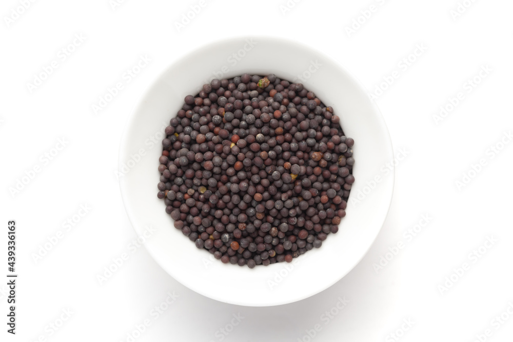 Macro close-up of Organic Black mustard seed (Brassica nigra) on white background. Pile of Indian Aromatic Spice. Top view Macro close-up of Organic Black mustard seed (Brassica nigra) on white background. Pile of Indian Aromatic Spice. Top view