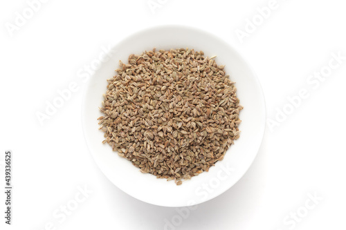 Macro close-up of Organic Ajwain seed (Trachyspermum ammi) or thymol seeds on white background. Pile of Indian Aromatic Spice. Top view photo