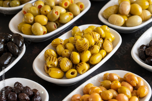 Assortment of olives on the plate in bulk. Organic black olives  Olive varieties