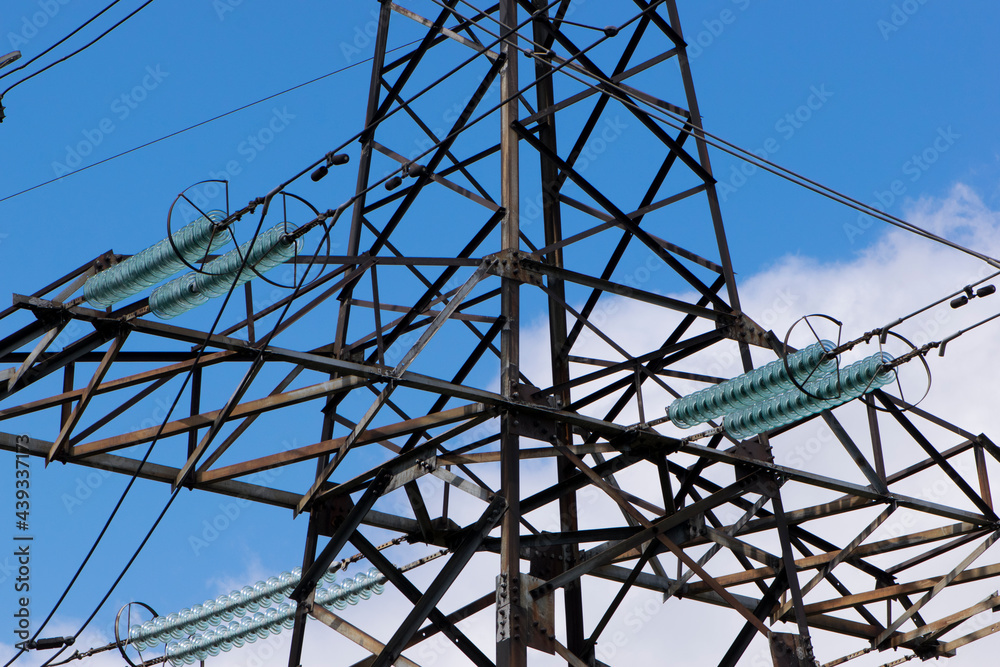 power line of cables and insulators close up. electrical insulators support cables placed on bracket installed on power pole. Clear blue sky without cloud background. Concept of industrial power line of cables and insulators close up. electrical insulators support cables placed on bracket installed on power pole. Clear blue sky without cloud background. Concept of industrial