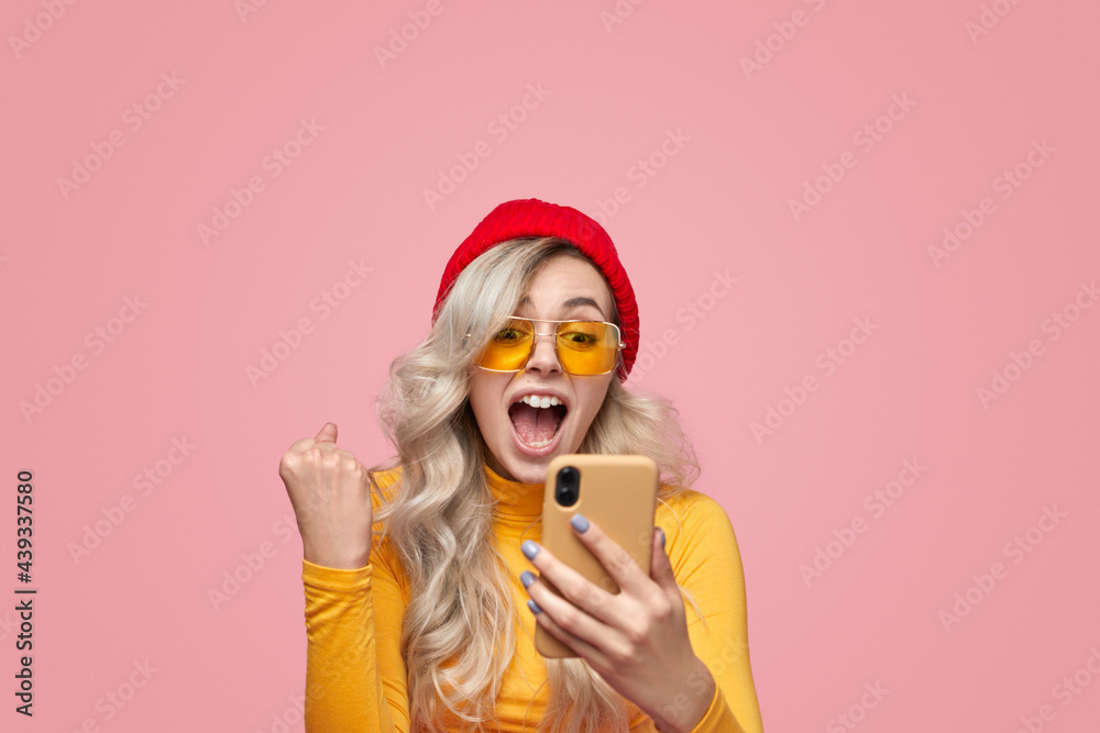 Excited woman with smartphone celebrating victory Excited woman with smartphone celebrating victory