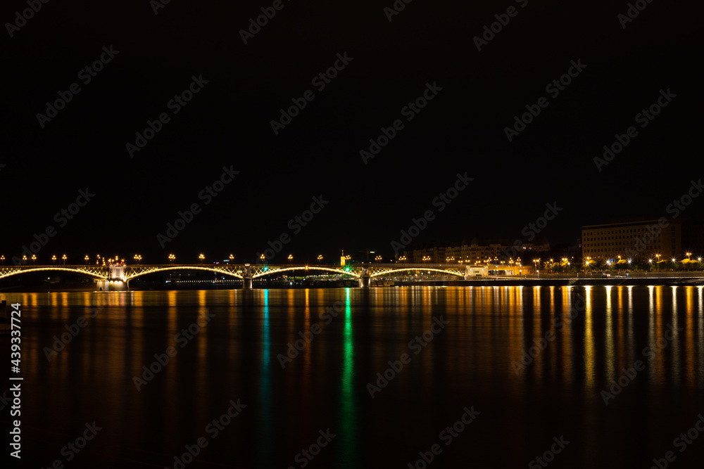 Night landscape with the lights of Budapest - Hungary reflected in the Danube water