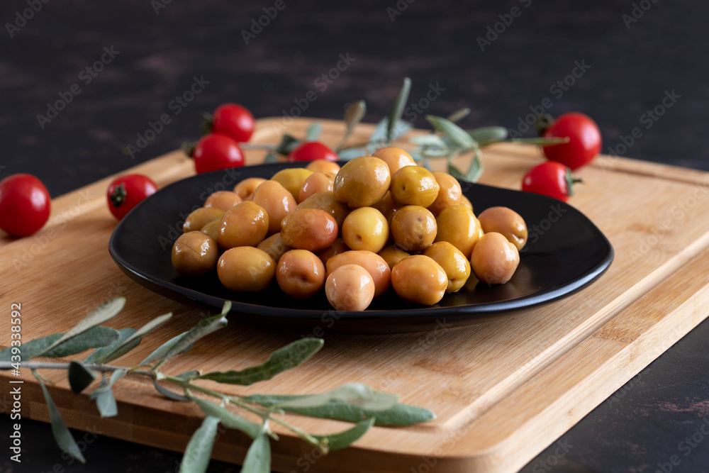 Delicious green olives. Tasty green olives in the plate. Delicious green olives. Tasty green olives in the plate.