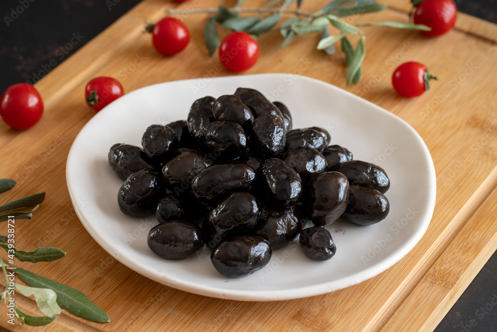 Kalamata olives. Tasty black kalamata olives in the plate. Kalamata olives. Tasty black kalamata olives in the plate.