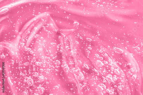 Pink mask smear smudge. Gel serum liquid, cream with collagen and retinol, ceramide sample. Hyaluronic acid toner with retinol and ceramide, jelly texture cosmetic product. Close-up, macro.