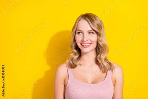 Photo of lovely blond hairdo young lady look empty space wear pink top isolated on bright yellow color background