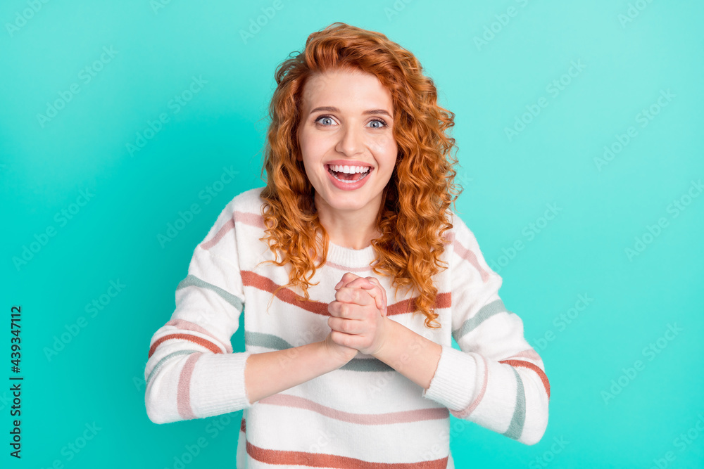 Photo portrait of curly woman keeping hands together asking cheerful isolated on vibrant teal color background