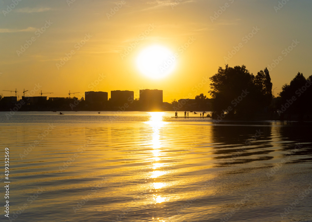 Sunset city silhouette reflecting in Sairan lake