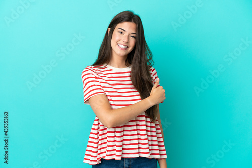 Young Brazilian woman isolated on blue background giving a thumbs up gesture © luismolinero