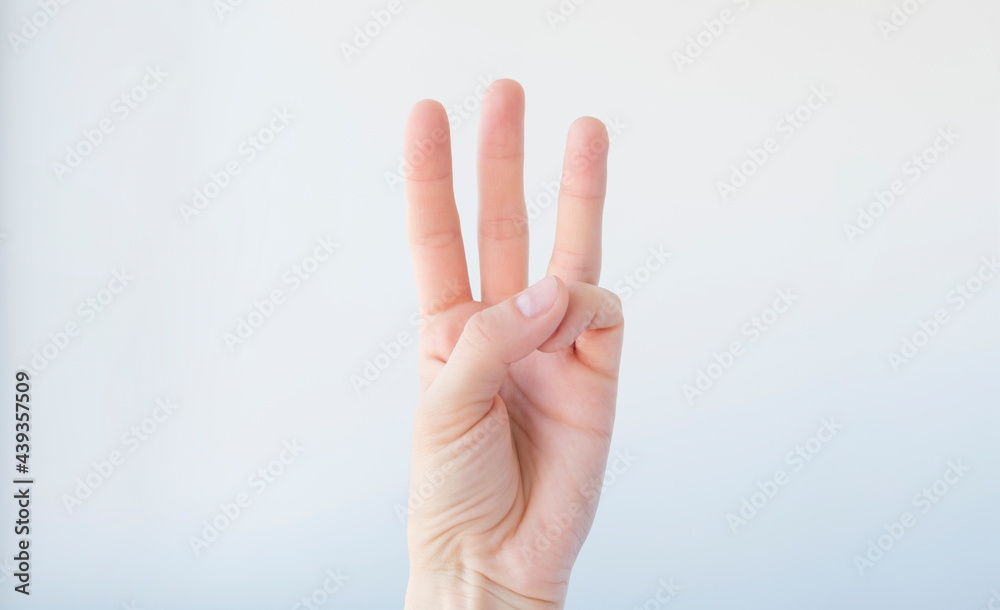Woman guide three fingers. On a white isolated background