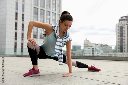 Beautiful woman doing fitness exercise in morning outdoors