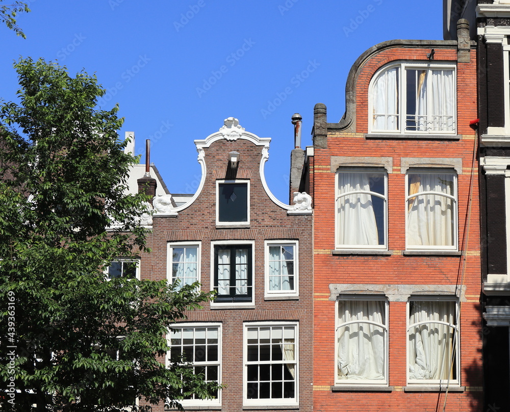 Amsterdam Canal House Facades Against a Blue Sky