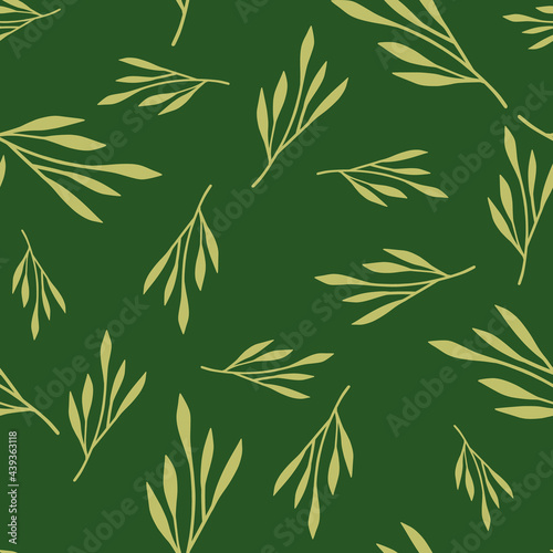 Random yellow leaf branches seamless doodle pattern. Green background. Foliage doodle backdrop.