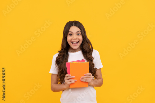 surprised school kid ready to study with book, knowledge