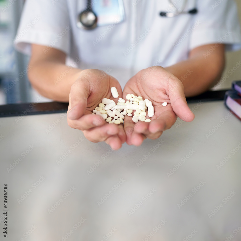 Pharmacy concept photo of doctor showing a large amount of pills in his hands Pharmacy concept photo of doctor showing a large amount of pills in his hands