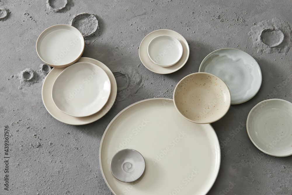 Ceramic tableware on grey background