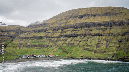 Village of Tjornuvik on Streymoy and dramatic mountain landscape on the Faroe Islands, Denmark, Europe