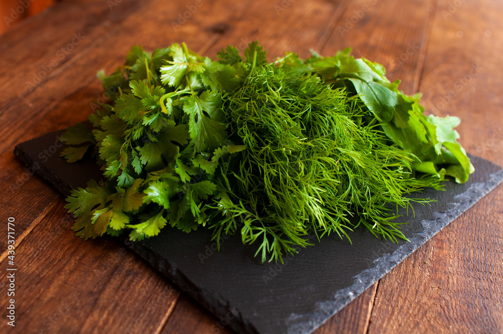 fresh arugula dill and parsley on a black board fresh arugula dill and parsley on a black board