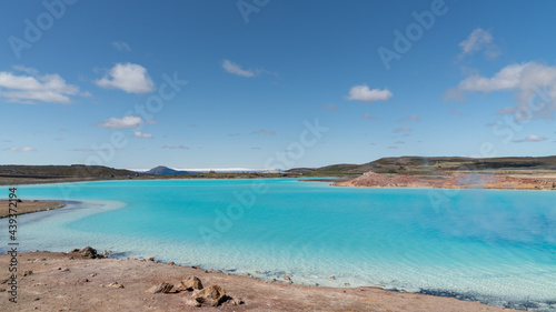 Blue lake in Hverir Myvatn geothermal area with boiling mudpools and steaming fumaroles in Iceland © CanYalicn