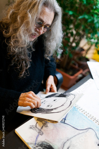 Artist hand drawing a portrait photo