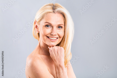 Close up portrait of a beautiful, attractive, charming, naked, nude woman touching her perfect skin, isolated on white background, after shower, peeling, lotion, mask, wellness, moisturizing concept.
