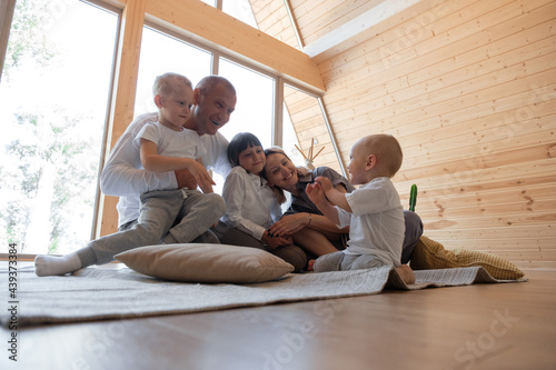 Happy family communicating with toddler on floor