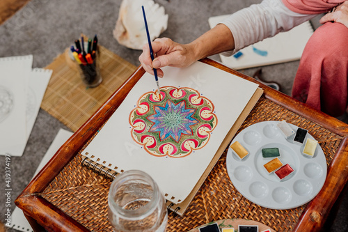 senior woman painting mandalas photo