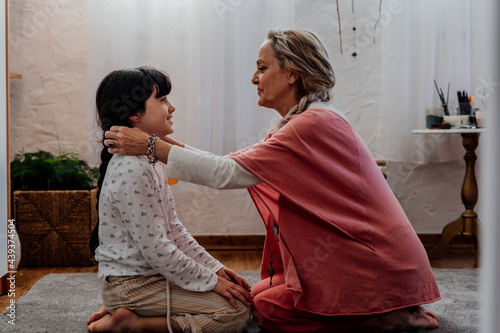 grandmother and granddaughter looking each other with tenderness 