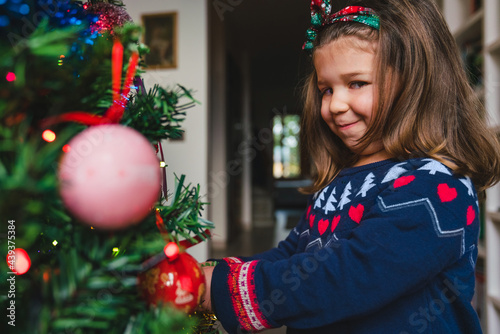 Funny Little Girl Decorating Christmas Tree