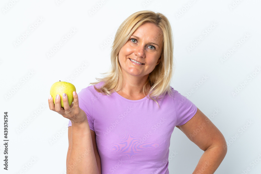 Middle age woman isolated on white background with an apple and happy Middle age woman isolated on white background with an apple and happy