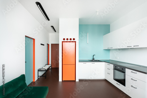 Minimalist living room / kitchen with blue, green and orange elements photo